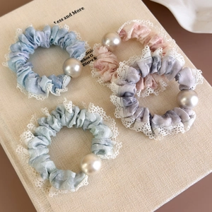 Set of four French-style lace scrunchies with marble dye texture and central pearl accent