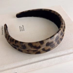 Detail view of leopard print headband on a book with non-slip black inner lining