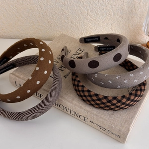 Set of 5 vintage padded headbands with polka dots and stripes on a rustic book