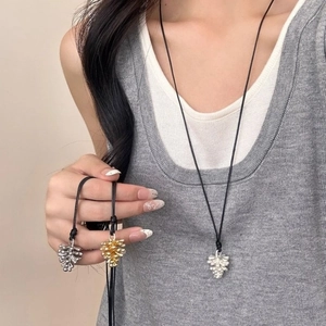 Adjustable pine cone pendant necklace in gold and silver finish with black cord