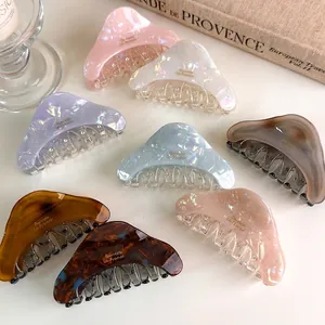 Colorful acetate claw clips in marble and pearl finish for elegant hair styling