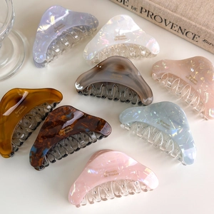 Detailed view of colorful acetate hair claws with gold Barrette la France lettering
