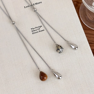 Close-up of adjustable silver snake chain with tiger eye teardrop pendant detail