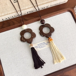 Detail view of retro coconut shell flower pendant necklaces with long tassels