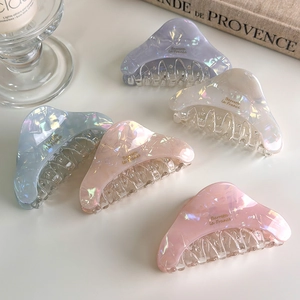 Detailed set of iridescent colorful acetate triangle hair claws with gold text accents