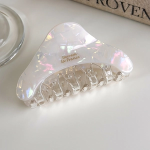 Detailed macro view of pearlescent acetate hair claw with Barrette la France gold lettering