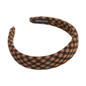 Brown checkered headband for women with handmade label on a clean white background