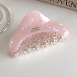 Close-up of iridescent acetate hair claw with Barrette la France golden lettering detail