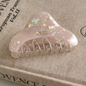 Detail of pink pearlescent acetate hair claw clip with gold Barrette la France text