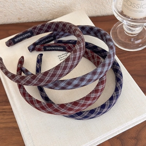 Classic American retro plaid fabric headband set with handmade label on a white book