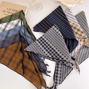 Close-up of retro plaid and striped triangle scarves with elegant wavy edge finish