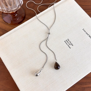 Detail of adjustable Y-shaped silver lariat necklace with tiger eye and teardrop pendants