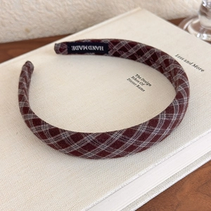 Detail of handmade vintage plaid headband with brown check pattern and fabric label