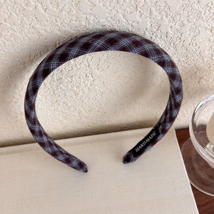 Detailed view of vintage burgundy plaid headband with handmade woven label