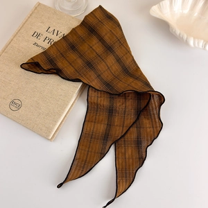 Detail of vintage brown plaid silk scarf with elegant black scalloped edge finish
