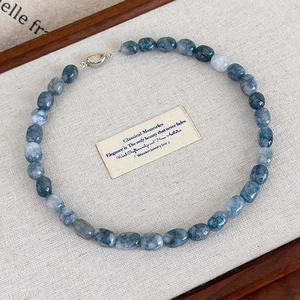 Detail of natural blue-grey marble stone beaded necklace with vintage silver clasp