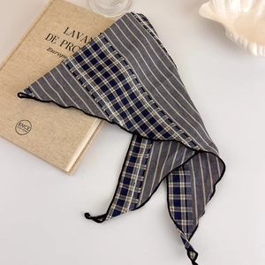 Close-up of retro plaid headscarf featuring blue stripes and fine stitching details