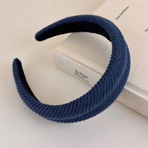 Macro shot of deep blue ribbed knit fabric texture on thick vintage hairband