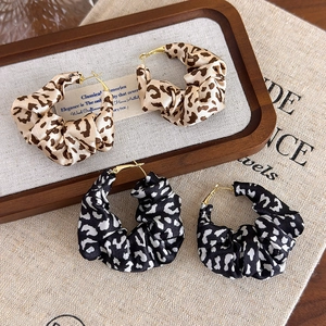 Exaggerated leopard print fabric earrings with gold metal hoops in French retro style
