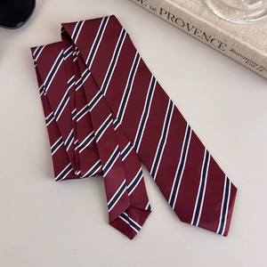 Detail of burgundy striped necktie with silky texture and classic diagonal pattern