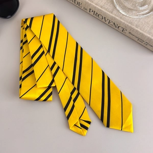 Close-up of yellow and black striped college style tie with subtle woven texture