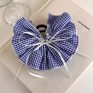 Detail of blue and white gingham hair claw with ruffled bow, ribbons and pearls