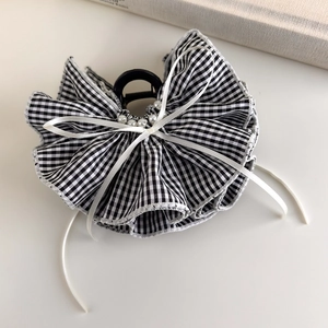 Detail of gingham fabric layers with faux pearl accents and white ribbon on hair claw
