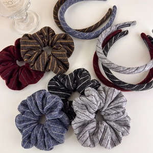 Detail of striped knitted scrunchies and headbands with handmade label for autumn