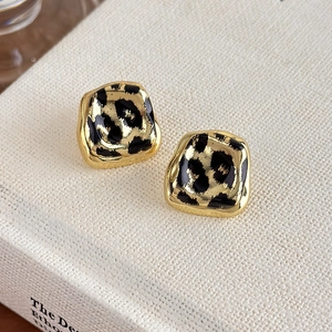 Detail view of vintage leopard print resin inlay on gold-plated geometric earrings