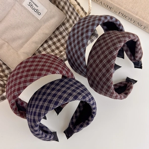 Detail of four retro plaid padded headbands in burgundy, navy, blue and coffee brown