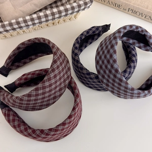 Detail of vintage plaid padded headbands in maroon and navy blue with sponge cushioning