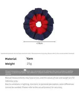 Detail view of a 14cm knitted oversized scrunchie in navy blue and red contrast color