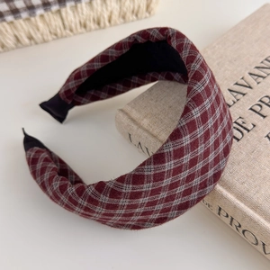 Detailed view of burgundy plaid padded headband with soft fabric texture and sponge filling