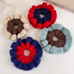 Detail showing set of four chunky knitted scrunchies in contrasting bicolor textures