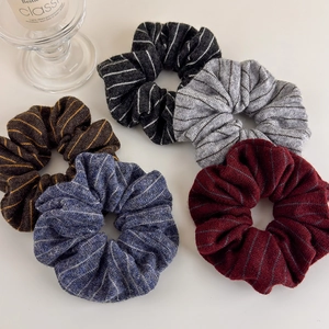 Detailed set of five knitted striped scrunchies in black, gray, brown, blue and red