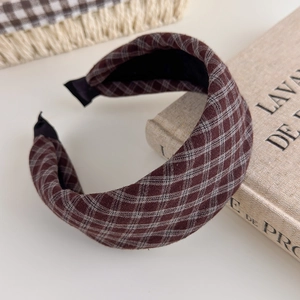 Detailed view of the wide vintage plaid headband with brown thick sponge fabric texture