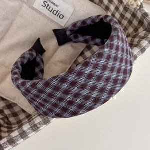 Close-up detail of vintage plaid sponge headband with brown and blue checkered fabric