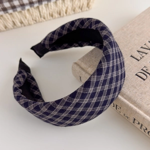 Detail view of the vintage navy blue plaid fabric and non-slip inner lining on the headband
