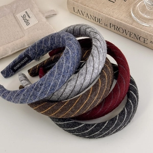 Chic padded knitted striped headbands in five elegant colors on a minimalist background