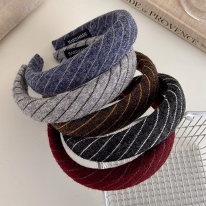 Close-up of handmade striped knit sponge headbands in various colors with wool texture