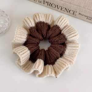 Close-up of dual-tone knit scrunchie with coffee and beige ribbed texture detail