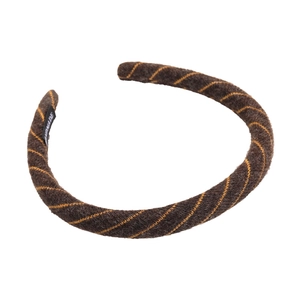Detail of handmade knitted headband featuring dark brown fabric and yellow diagonal stripes
