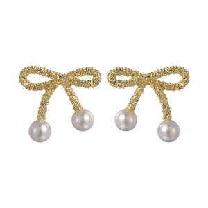 Elegant gold bow earrings with white pearls and textured beadwork for women