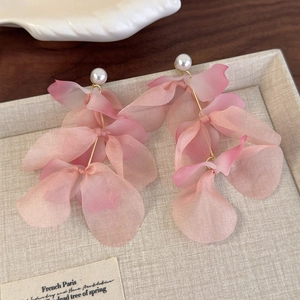 Detailed macro view of pink gradient fabric flower tassel earrings with white pearl accents