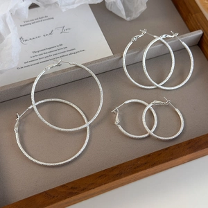 Three-piece set of silver frosted hoop earrings in small medium and large sizes