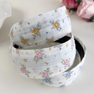 Détail de serre-têtes à fleurs avec dents antidérapantes et texture en maille blanche