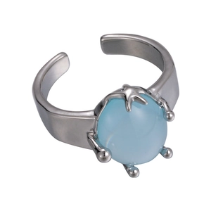Macro view of adjustable starfish ring with blue stone and coral-shaped silver prongs