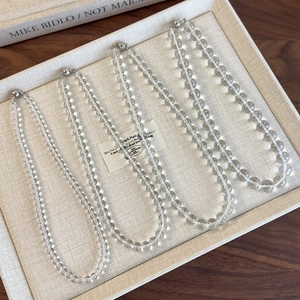 Chic transparent acrylic beaded choker necklaces set in four sizes on a jewelry tray