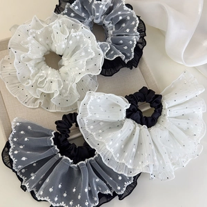 Set of four oversized lace dot scrunchies in black and white mesh with ruffled edges