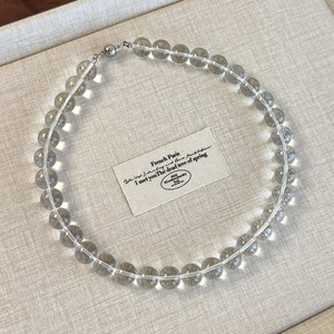 Detail view of transparent gray crystal beads and magnetic clasp on a choker necklace